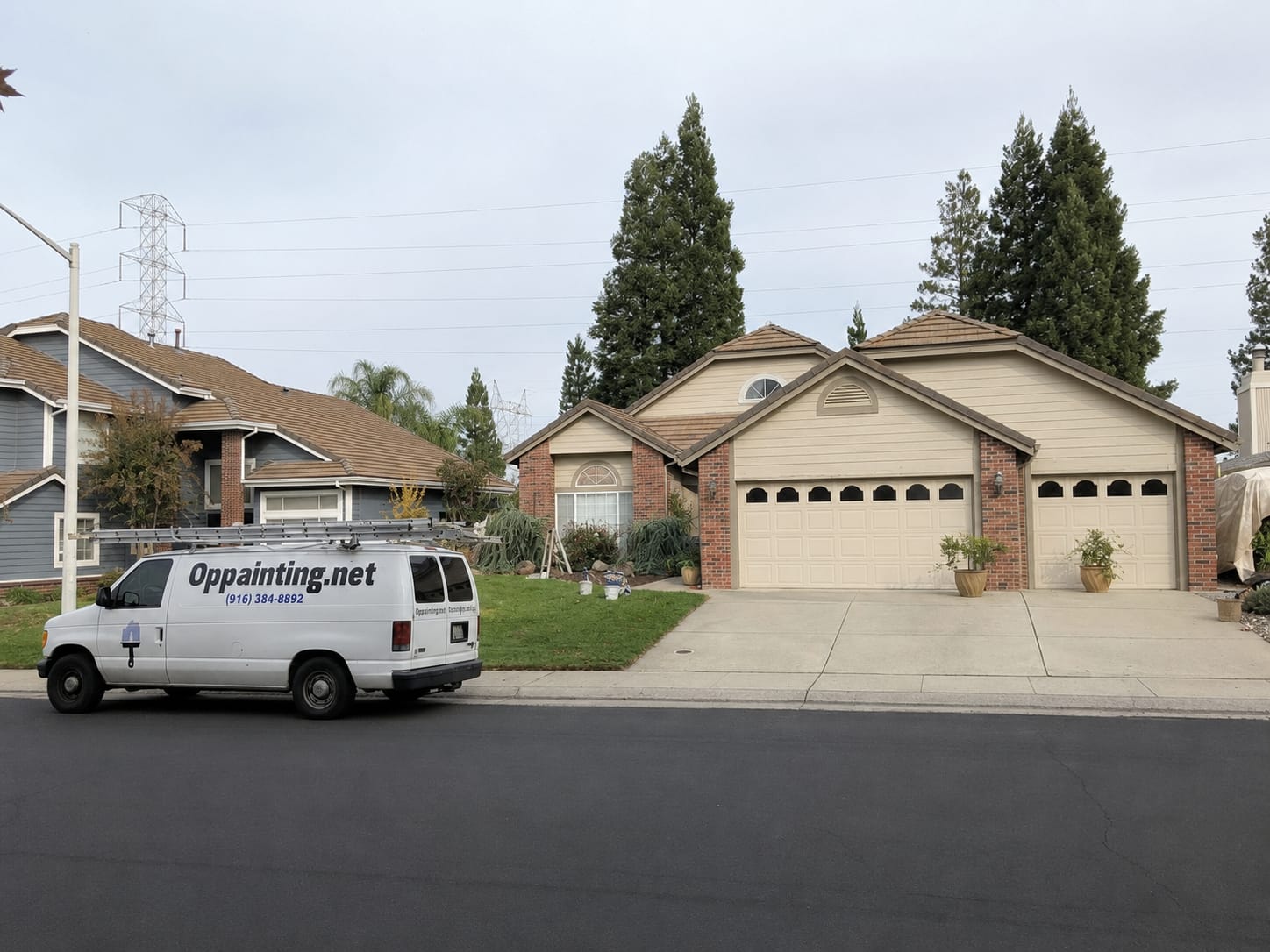 A single-storey Roseville home with brick facing and two garage doors before the repaint, with the company van parked at the kerb, an extension ladder on its roof rack and paint pails set out on the lawn.