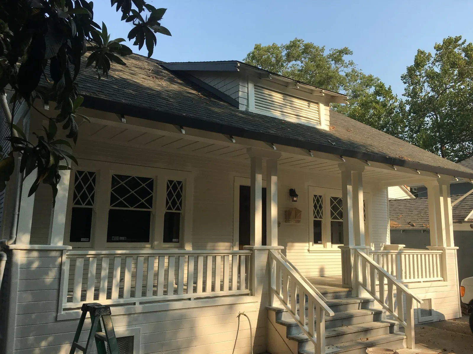 Classic White Craftsman Bungalow with Spacious Front Porch and Lattice Windows