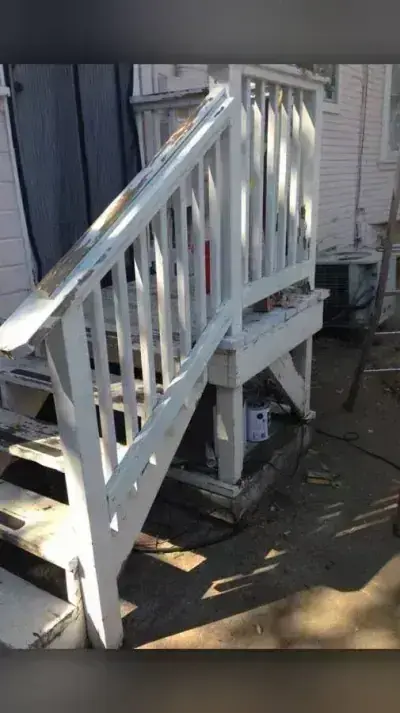 Weathered White Wooden Deck Stairs with Peeling Paint and Exposed Wood Base