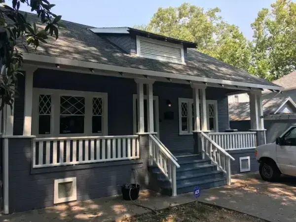 Blue Craftsman-Style Bungalow with White Trim and Large Front Porch