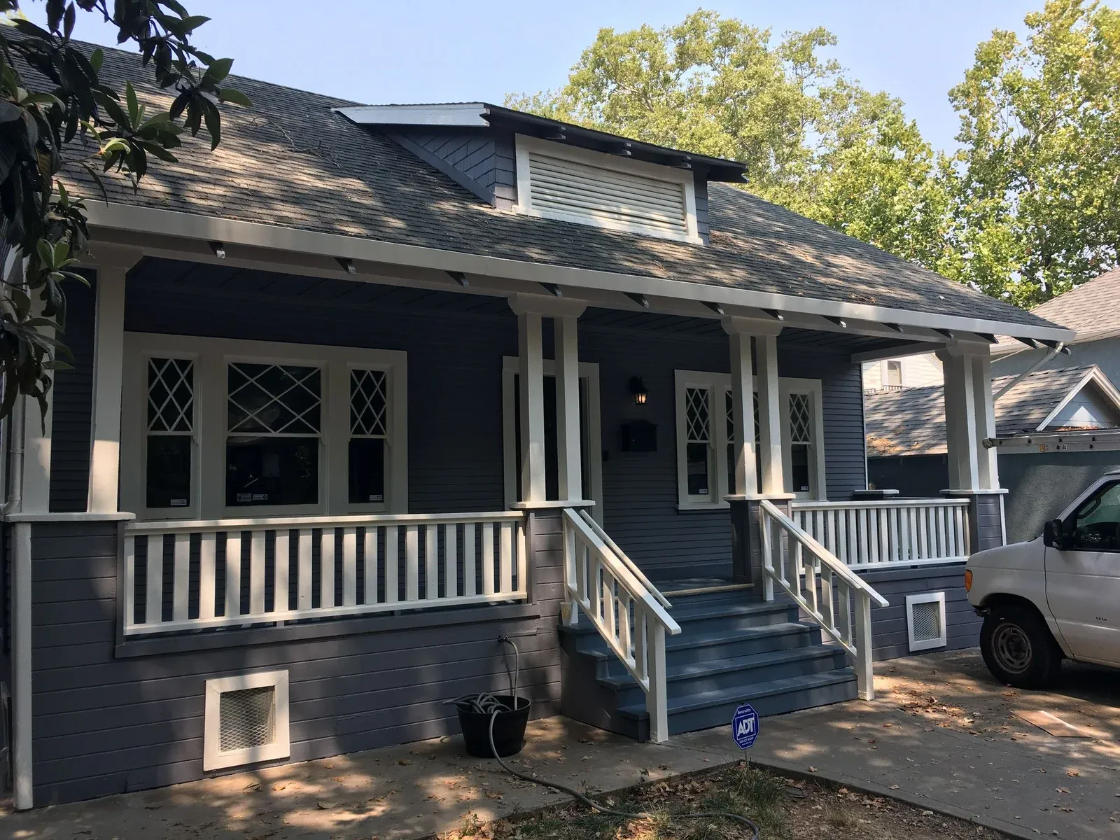 Blue Craftsman-Style Bungalow with White Trim and Large Front Porch